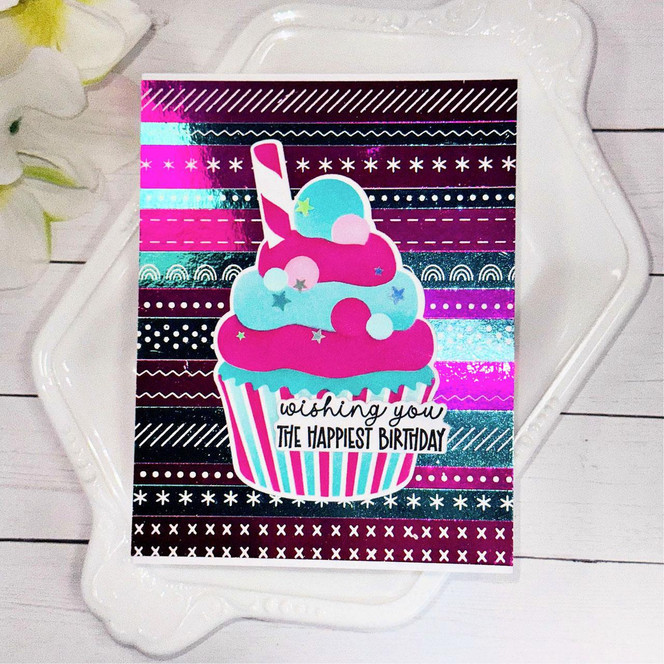 Handmade greeting card of easy strips patterns with a cupcake on it and wishing you the happiest birthday sentiment on it.