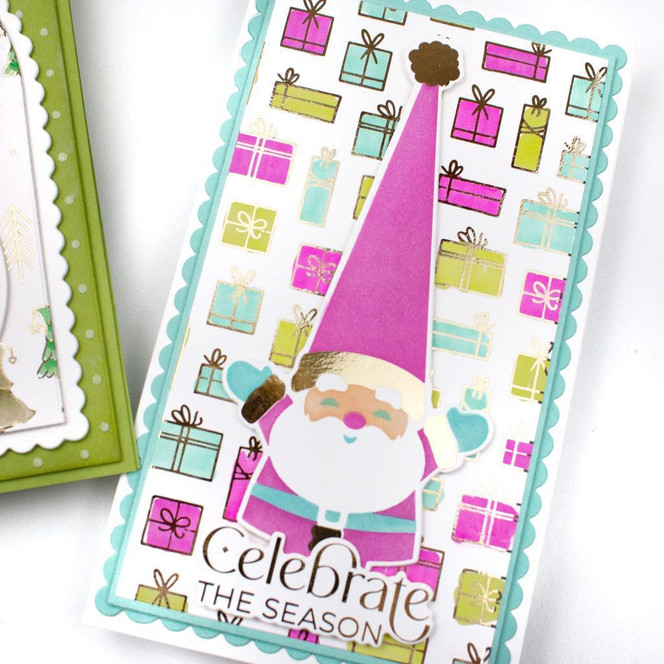Handmade greeting card with santa on it and presents in the background with celebrate the season sentiment on it.