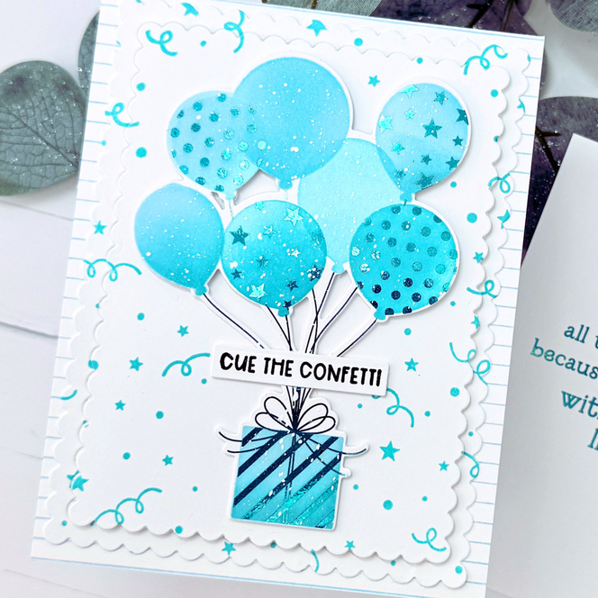 Handmade greeting card with balloons holding a present up with cue the confetti sentiment on it.