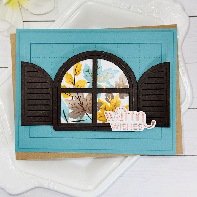Handmade greeting card with open window and fall leaves in it with warm wishes sentiment on it.