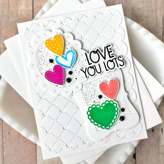 Handmade greeting card with hearts on it and love you lots sentiment on it.
