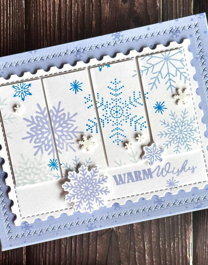 Handmade greeting card with snowflakes on it and warm wishes sentiment on it.