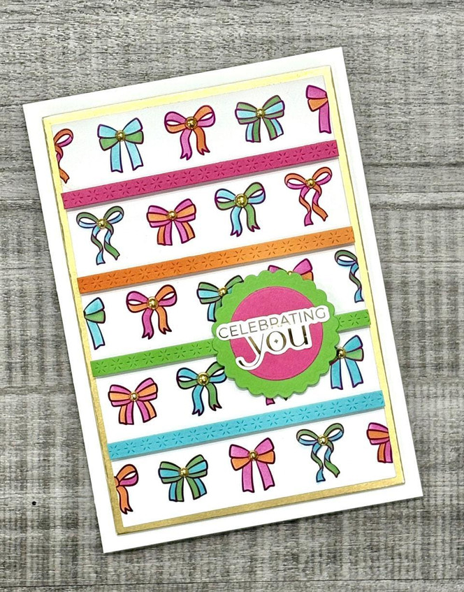 Handmade greeting card with bows on it and celebrating you sentiment on it.
