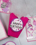 Handmade greeting tag with happy birthday sentiment on it and confetti.