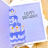 Inside of a handmade greeting card with cake on it and happy birthday sentiment on it.