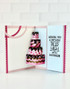Inside of a handmade greeting card with cake on it and wishing you a birthday piled high with happiness sentiment on it.