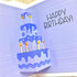 Handmade greeting card with cake inside it and happy birthday sentiment on it.