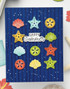 Handmade greeting card with seashells on it and happy summer sentiment on it.