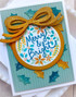 Handmade greeting card with ornament on it and a bow with merry & bright sentiment on it.
