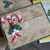 Handmade greeting card with candy canes on it and 'tis the season sentiment on it.