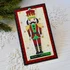 Handmade greeting card with a nutcracker on it and Merry Christmas sentiment on it.