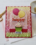 Handmade greeting card with balloons on it and happy birthday sentiment on it.