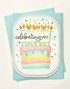 Handmade greeting card with cake on it and celebrating you sentiment on it.