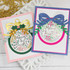 Two handmade greeting cards with ornaments on each and different holiday sentiments on each.