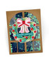 Handmade greeting card with wreath on it and season's greetings sentiment on it.