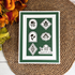 Handmade gratitude card featuring white and gold foiled botanical medallions on a dark green background with a With Gratitude sentiment.