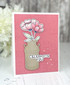 Handmade greeting card with flower in vase and celebrate you sentiment on it.