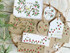 Handmade gift tags with various holiday flowers on them and holiday sentiments on each.