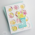 Handmade greeting card with flowers on it and love you bunches sentiment on it with cardstock in background.