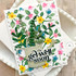Handmade greeting card with flower son it and get well soon sentiment on it with cardstock in background.