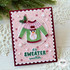 Handmade greeting card with a sweater on it with a snowman and it's sweater weather sentiment on it.