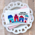 Handmade greeting card with houses and clouds on it and from our home to yours sentiment on it.