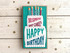 Handmade greeting card with layered cake on it with did someone say cake? happy birthday sentiment on it with sparkles in the background.