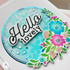 Handmade greeting card with a floral circle on it and hello lovely sentiment on it.