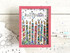 Handmade greeting card with candles on it and sparkles with make a wish sentiment on it with crafting materials in the background.