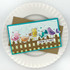 Handmade greeting card with doodle birds on fence with you're so tweet sentiment on a plate in background.