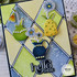 Handmade greeting card with hello there sentiment and flowers in vases with craft supplies in background.