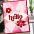 Handmade greeting card with hello sentiment with flowers in background.