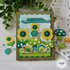 Handmade greeting card with snails, flowers, and mushrooms with sorry I'm slow... Happy belated birthday sentiment on it with mushrooms and snails in background.