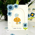 Handmade greeting card with mushrooms, flowers, and a snail with sorry I'm slow... sentiment on it with flowers and snails in the background.