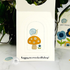 Handmade greeting card with a mushroom, snail, and flower on it with happy belated birthday sentiment on it with cards in background.