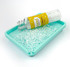 Clear container filled spilling onto tray with small cube-shaped embellishments resembling ice cubes, designed for use in paper crafting projects.