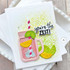 Handmade greeting card with a drink cup, citrus fruit, and you're the zest sentiment on it with cardstock in the background.