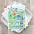 Handmade greeting card that is carnival themed with sending lots of happy on your birthday sentiment on it with cardstock in background.