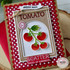 Handmade greeting card with tomatoes on it and scatter seeds of kindness sentiment on it with cardstock and a plant in the background. Handmade greeting card with tomatoes on it and scatter seeds of kindness sentiment on it with cardstock and a plant in the background.