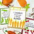 Handmade greeting card with carrots on it and I carrot 'bout you a whole bunch sentiment on it with crafting materials and cards in the background.