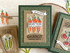 Handmade greeting card with carrots on it and scatter seeds of kindness sentiment on it with crafting materials in the background.