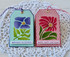 Two handmade greeting tags with flowers on it and one with birthday blessings sentiment and the other with happy happy birthday sentiment on it.