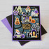 Handmade greeting card with haunted house, monsters, pumpkins, a cat, and haunted hello sentiment on it.