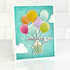 Handmade greeting card with balloons holding up a present with celebrating you sentiment on it.
