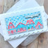 Handmade greeting card with houses on it with snowflakes with let it snow sentiment on it.