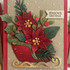 Handmade greeting card with flowers in a sleigh with season's greetings sentiment on it.