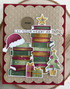 Handmade greeting card with books and santa hat on it with let your heart e light sentiment on it.