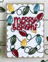 Handmade greeting card with Christmas lights on it and merry & bright sentiment on it.