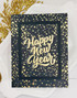 Handmade greeting card with sparkles on it and happy new year sentiment on it.