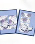 Two handmade greeting cards with snow flakes on each of them with one having warm wishes sentiment on it and the other having let it snow sentiment on it.